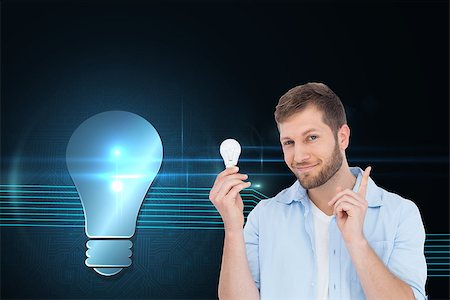 Composite image of charming model holding a bulb in right hand Stock Photo - Budget Royalty-Free & Subscription, Code: 400-07225809