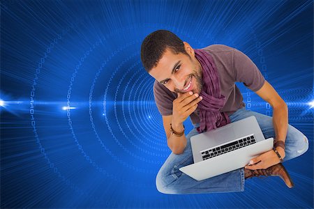 simsearch:400-07224720,k - Composite image of thoughtful man sitting on floor using laptop and smiling at camera Stock Photo - Budget Royalty-Free & Subscription, Code: 400-07226042