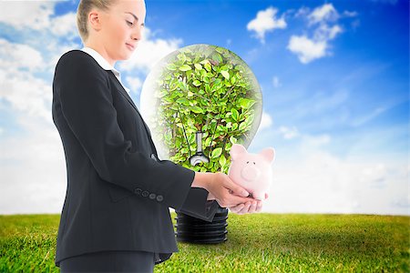 simsearch:400-07220226,k - Composite image of blonde businesswoman holding piggy bank Stockbilder - Microstock & Abonnement, Bildnummer: 400-07226108