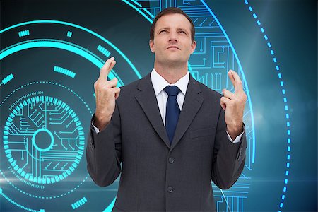 simsearch:400-07258010,k - Composite image of serious businessman with fingers crossed is looking up Foto de stock - Royalty-Free Super Valor e Assinatura, Número: 400-07226101