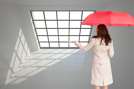 Composite image of brunette businesswoman holding umbrella Photographie de stock - Aubaine LD & Abonnement, Code: 400-07226186