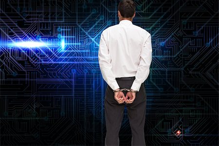 simsearch:400-07225597,k - Composite image of rear view of young businessman wearing handcuffs Stock Photo - Budget Royalty-Free & Subscription, Code: 400-07226823