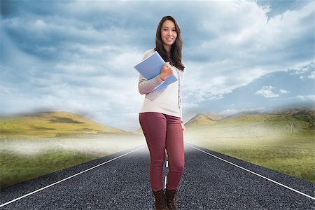 Composite image of student standing in a computer room and holding a folder while smiling Stock Photo - Budget Royalty-Free & Subscription, Code: 400-07226872