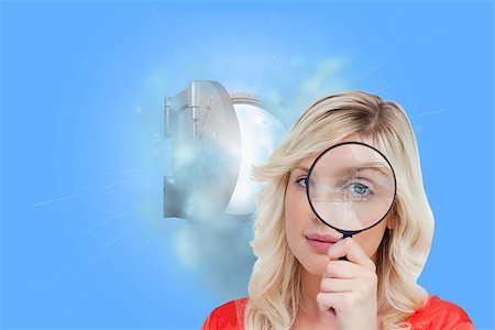 Composite image of fair-haired woman looking through a magnifying glass Stock Photo - Budget Royalty-Free & Subscription, Code: 400-07227827