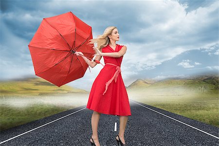 simsearch:400-07220030,k - Composite image of beautiful woman posing with a broken umbrella with her leg raised Stock Photo - Budget Royalty-Free & Subscription, Code: 400-07227823