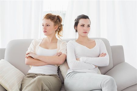 fighting friends on couch - Unhappy young female friends not talking after argument at home on the couch Stock Photo - Budget Royalty-Free & Subscription, Code: 400-07228102
