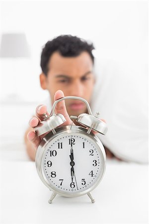 simsearch:614-02613098,k - Close-up of a blurred young man in bed extending hand to alarm clock at home Stockbilder - Microstock & Abonnement, Bildnummer: 400-07228417