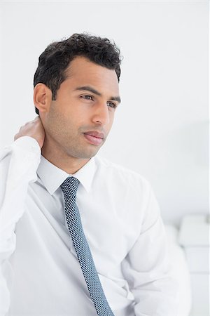 Young businessman suffering from neck pain in bed at home Stock Photo - Budget Royalty-Free & Subscription, Code: 400-07228465