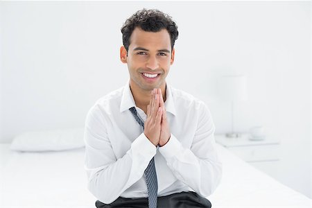 sophisticated home smile - Portrait of a smiling young businessman sitting on bed at home Stock Photo - Budget Royalty-Free & Subscription, Code: 400-07228468