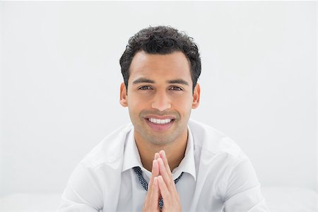 sophisticated home smile - Portrait of a smiling young businessman sitting on bed at home Stock Photo - Budget Royalty-Free & Subscription, Code: 400-07228482