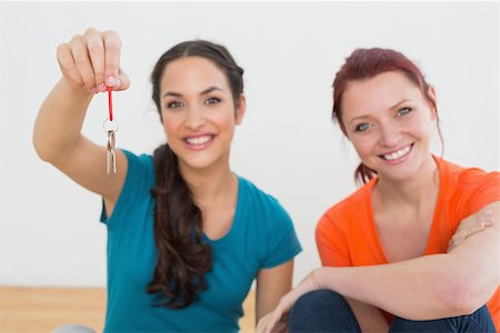 Close-up portrait of two cheerful female friends with keys in the new house Stock Photo - Budget Royalty-Free & Subscription, Code: 400-07229416