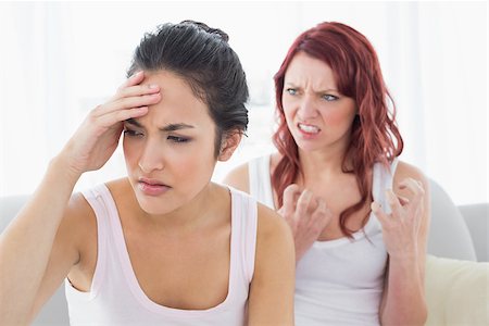 friends home upset - Angry young female friends having an argument in the living room at home Stock Photo - Budget Royalty-Free & Subscription, Code: 400-07229625