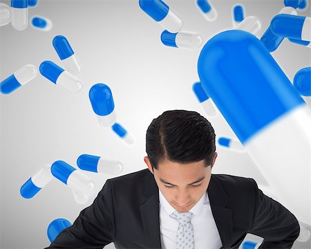 pharmaceutical medicine of floating tablets - Composite image of unsmiling asian businessman pointing Stock Photo - Budget Royalty-Free & Subscription, Code: 400-07220284