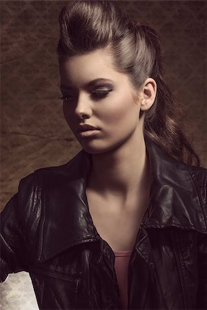 close-up portrait of cute brunette lady with dark style posing with modern curly hair-style and leather jacket Stock Photo - Budget Royalty-Free & Subscription, Code: 400-07221270