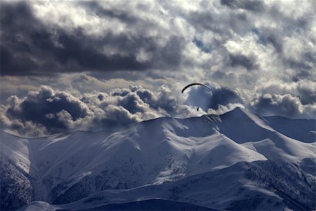 simsearch:400-05157183,k - Evening mountain with clouds and silhouette of parachutist. Caucasus Mountains. Georgia, ski resort Gudauri. Photographie de stock - Aubaine LD & Abonnement, Code: 400-07221327