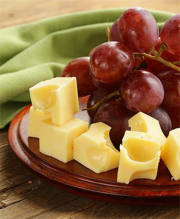 simsearch:400-05682309,k - wooden plate with cheese (Maasdam) and red grapes Stock Photo - Budget Royalty-Free & Subscription, Code: 400-07221416