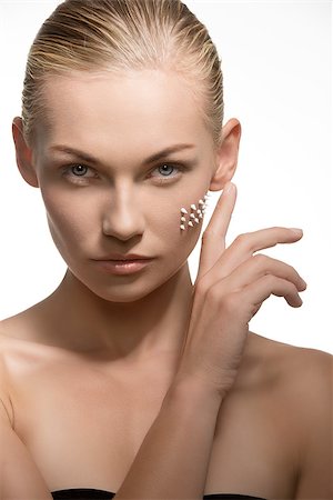 close-up portrait of cute blonde lady taking care of her visage skin. Applying beauty cosmetic treatment on her face. Preparing for perfect make-up Stock Photo - Budget Royalty-Free & Subscription, Code: 400-07221484