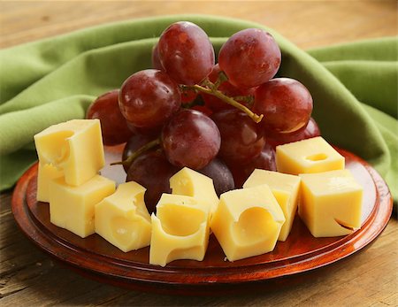 simsearch:400-05682309,k - wooden plate with cheese (Maasdam) and red grapes Stock Photo - Budget Royalty-Free & Subscription, Code: 400-07221542
