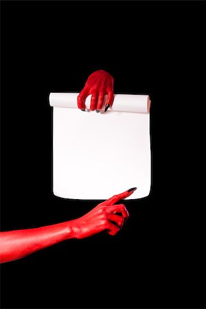 simsearch:400-07210691,k - Red devil hands holding paper scroll and pointing at signature place, isolated on black background Stock Photo - Budget Royalty-Free & Subscription, Code: 400-07221628