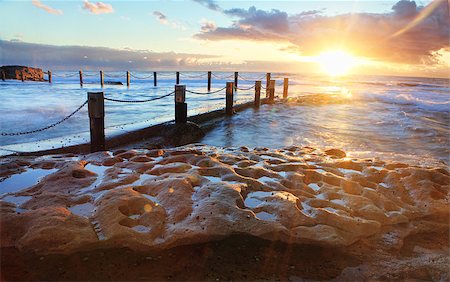 Golden rays of sunlight emerge at sunrise at the idyllic Mahon pool located on exposed rock shelf at Maroubra, Sydney Australia Stock Photo - Budget Royalty-Free & Subscription, Code: 400-07221953