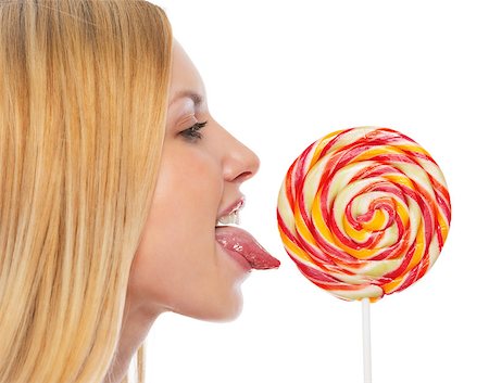 Profile portrait of teenage girl licking lollypop Stock Photo - Budget Royalty-Free & Subscription, Code: 400-07222004