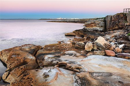 sydney cove - Botany Bay Australia at first light dawn (before sunrise) with beautiful multi coloured sandstone rocks and boulders in the foreground and the pink and blue sky hues reflected in it's serene waters.  Botany Bay was the bay of Captain James Cook's first landing   Long exposure, bracketed Foto de stock - Super Valor sin royalties y Suscripción, Código: 400-07222039
