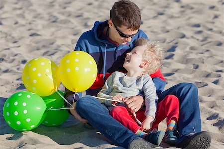 happy cheerful family of two spending fun time with balloons at the beach Stock Photo - Budget Royalty-Free & Subscription, Code: 400-07222231