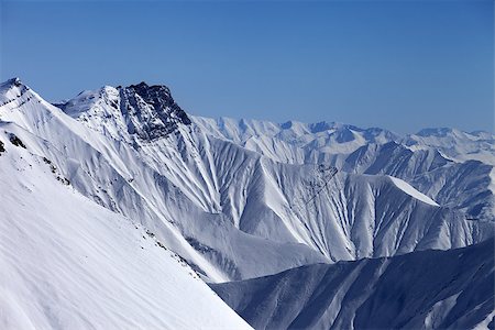 simsearch:400-09170509,k - Snowy winter mountains in haze. Caucasus Mountains, Georgia, view from ski resort Gudauri. Photographie de stock - Aubaine LD & Abonnement, Code: 400-07222349