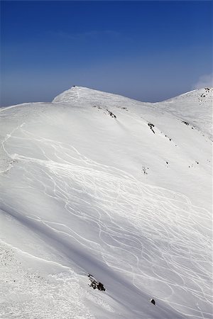 simsearch:400-08780271,k - Off-piste ski slope with traces. Caucasus Mountains, Georgia, ski resort Gudauri. Photographie de stock - Aubaine LD & Abonnement, Code: 400-07223261