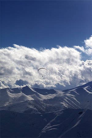simsearch:400-05157183,k - Winter mountain in evening and silhouette of parachutist. Caucasus Mountains. Georgia, ski resort Gudauri. Photographie de stock - Aubaine LD & Abonnement, Code: 400-07223272