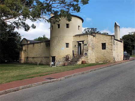The Old Provost is a military prison finished in early 1838 as part of the Governor's 1835 defensive plan for Grahamstown. Built to a unique design in the British Cape Colony it was designed to allow for constant surveillance of the prisoners as the prison is shaped as a quarter circle with eight cells surrounding the exercise yard. The building is now preserved and used as a cafe. Stock Photo - Budget Royalty-Free & Subscription, Code: 400-07223589