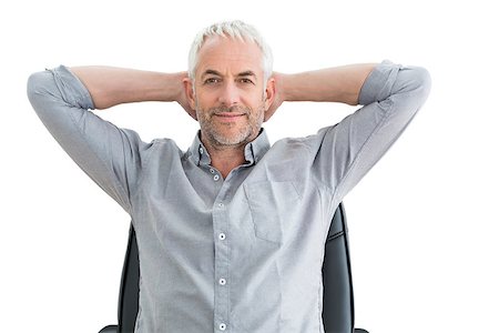 Portrait of a relaxed mature businessman with hands behind head over white background Photographie de stock - Aubaine LD & Abonnement, Code: 400-07230801