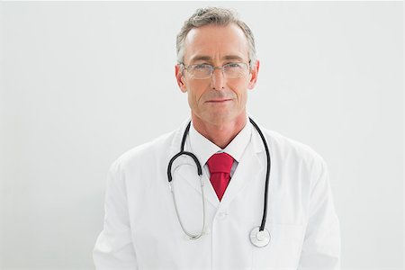 simsearch:632-03630033,k - Portrait of a serious confident male doctor standing over white background Stock Photo - Budget Royalty-Free & Subscription, Code: 400-07230955