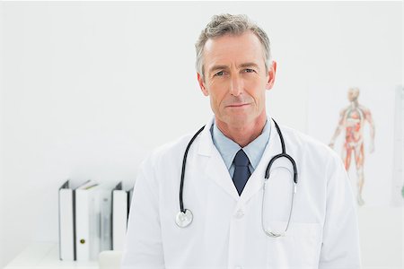 simsearch:614-06898452,k - Portrait of a serious confident male doctor standing in the medical office Stock Photo - Budget Royalty-Free & Subscription, Code: 400-07230989