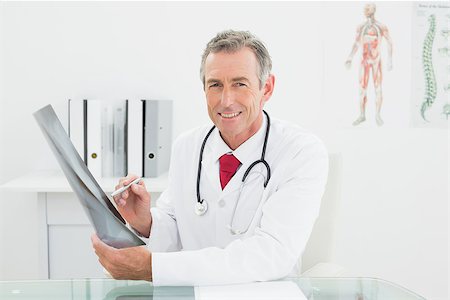 simsearch:400-07269250,k - Portrait of a smiling male doctor with x-ray picture of lungs in the medical office Stock Photo - Budget Royalty-Free & Subscription, Code: 400-07230982