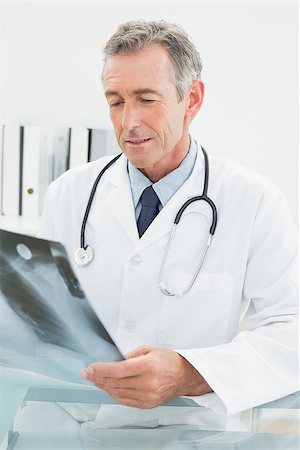 simsearch:400-07269250,k - Concentrated male doctor looking at x-ray picture of lungs in the medical office Stock Photo - Budget Royalty-Free & Subscription, Code: 400-07230991