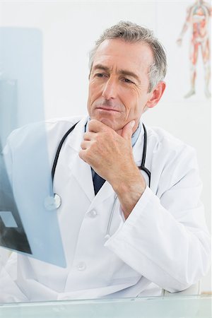 simsearch:400-07778150,k - Concentrated male doctor looking at x-ray picture in the medical office Stock Photo - Budget Royalty-Free & Subscription, Code: 400-07231009