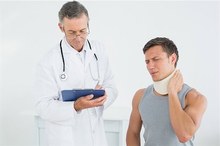 simsearch:400-07269643,k - Male doctor listening to patient with concentration at medical office Fotografie stock - Microstock e Abbonamento, Codice: 400-07231195