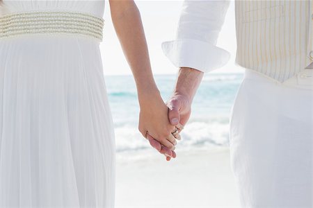 Newlyweds holding hands at the beach Stock Photo - Budget Royalty-Free & Subscription, Code: 400-07231270