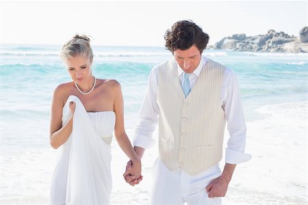 simsearch:400-07664797,k - Newlyweds walking hand in hand  at the beach Stock Photo - Budget Royalty-Free & Subscription, Code: 400-07231281