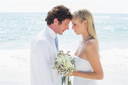 simsearch:400-07664797,k - Happy couple embracing each other on their wedding day at the beach Stock Photo - Budget Royalty-Free & Subscription, Code: 400-07231506