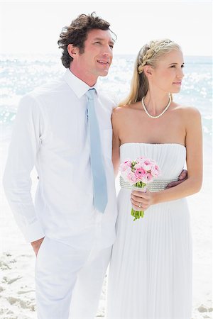 simsearch:400-07664797,k - Couple standing together on their wedding day looking away at the beach Stock Photo - Budget Royalty-Free & Subscription, Code: 400-07231525