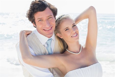 simsearch:400-07664797,k - Newlyweds smiling at camera at the beach Stock Photo - Budget Royalty-Free & Subscription, Code: 400-07231530