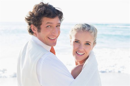 simsearch:400-07664797,k - Newlyweds standing by the sea looking at the camera at the beach Stock Photo - Budget Royalty-Free & Subscription, Code: 400-07231546