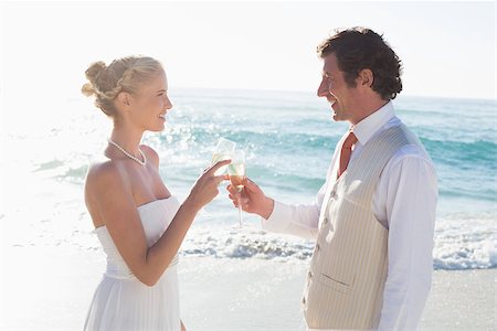 simsearch:400-07664797,k - Newlyweds toasting with champagne at the beach Stock Photo - Budget Royalty-Free & Subscription, Code: 400-07231551