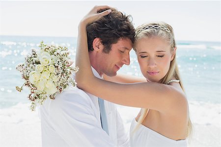 simsearch:400-07664797,k - Romantic couple embracing on their wedding day at the beach Stock Photo - Budget Royalty-Free & Subscription, Code: 400-07231564