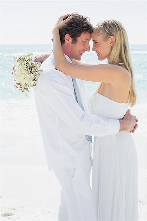 simsearch:400-07664797,k - Couple embracing each other on their wedding day at the beach Stock Photo - Budget Royalty-Free & Subscription, Code: 400-07231568
