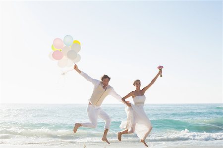 simsearch:400-07664797,k - Newlyweds having fun holding balloons at the beach Stock Photo - Budget Royalty-Free & Subscription, Code: 400-07231562