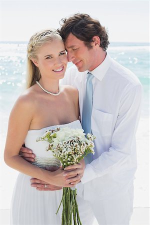 simsearch:400-07664797,k - Content couple on their wedding day bride smiling at camera at the beach Stock Photo - Budget Royalty-Free & Subscription, Code: 400-07231570