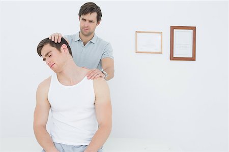 simsearch:400-07232187,k - Male chiropractor doing neck adjustment in the medical office Foto de stock - Royalty-Free Super Valor e Assinatura, Número: 400-07232070